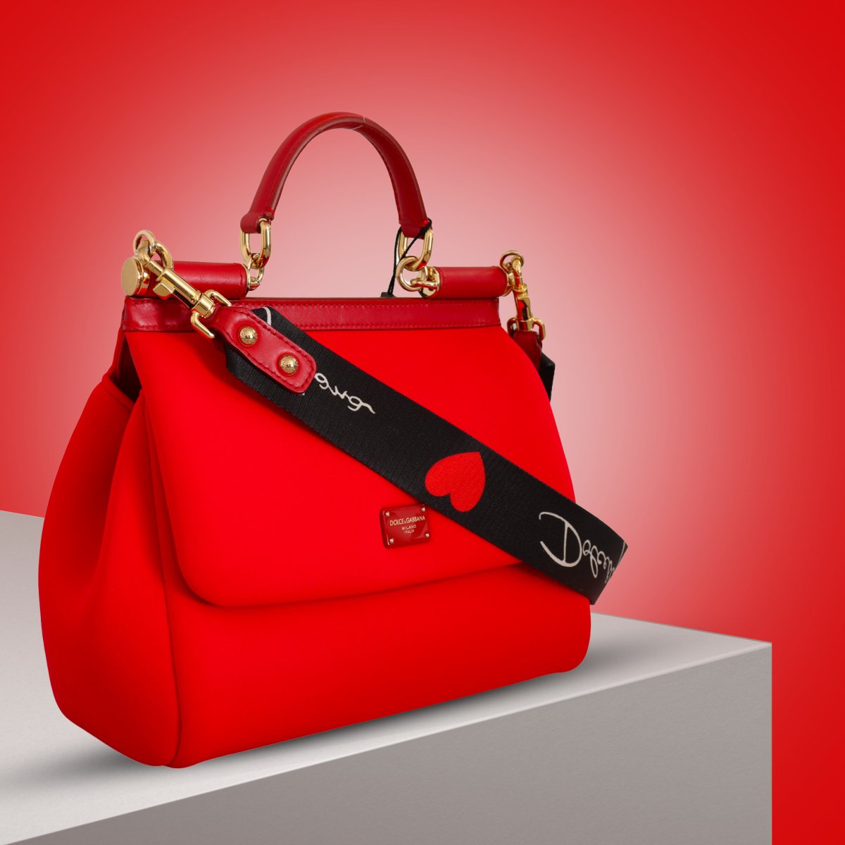 red dolce gabbana bag with heart logo strap